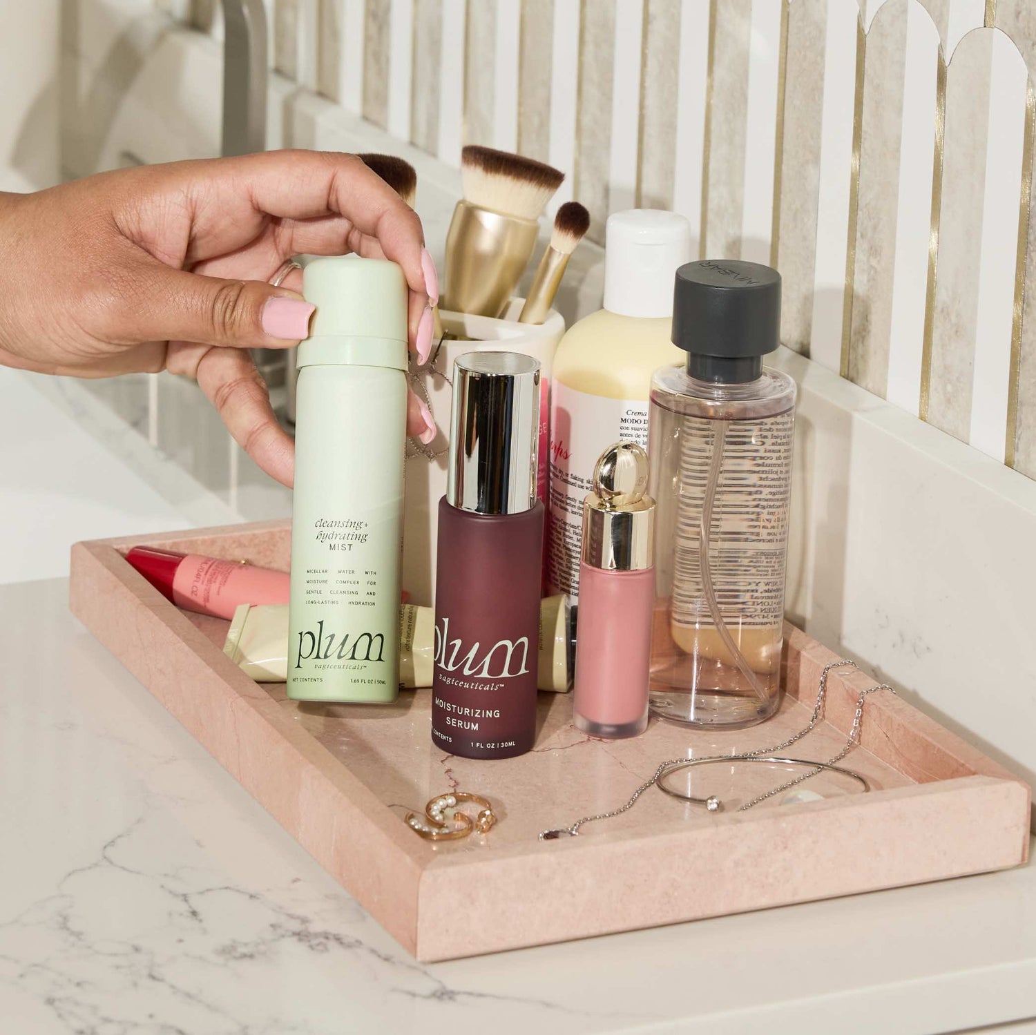 Plum Cleansing Hydrating Mist and Moisturizing Serum displayed on a vanity tray, perfect for daily hydration and self-care